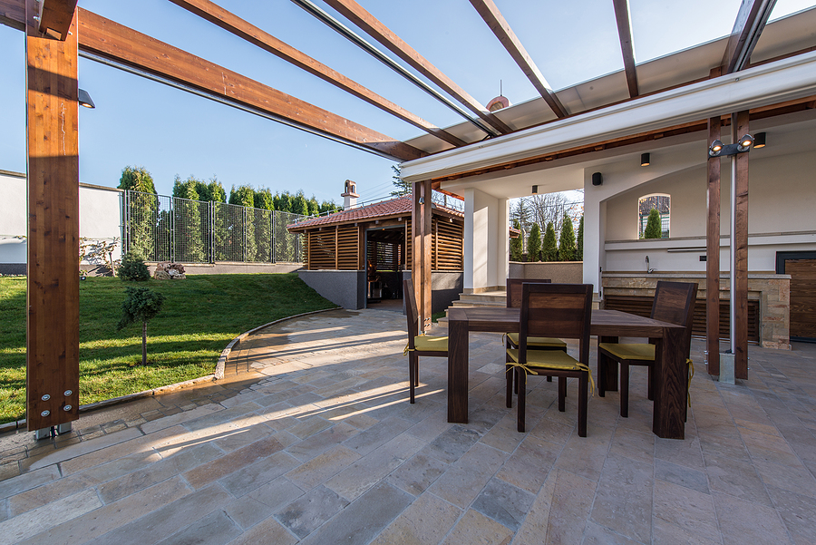 Beautiful terrace lounge with pergola and wooden table with chairs